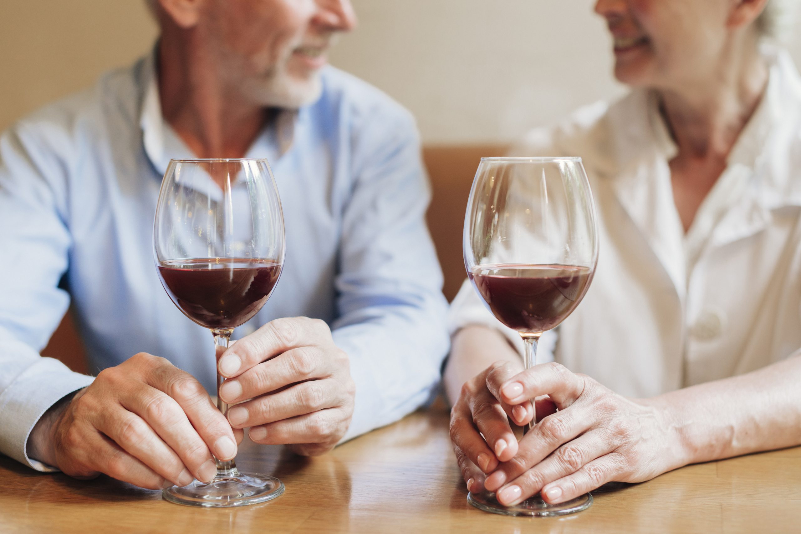 starší pár si pripíja s pohárom červeného vína