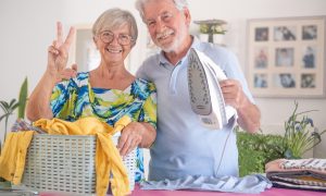 Pár seniorov, ktorí spolu žehlia