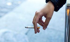 žena držiaca cigaretu